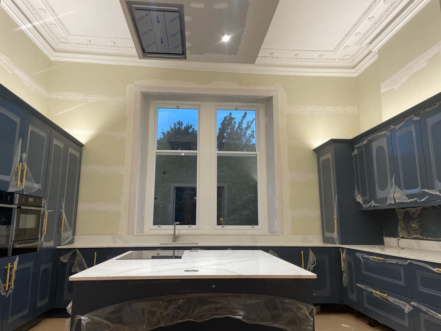 Navy kitchen cornice being fitted during a Glasgow kitchen installation