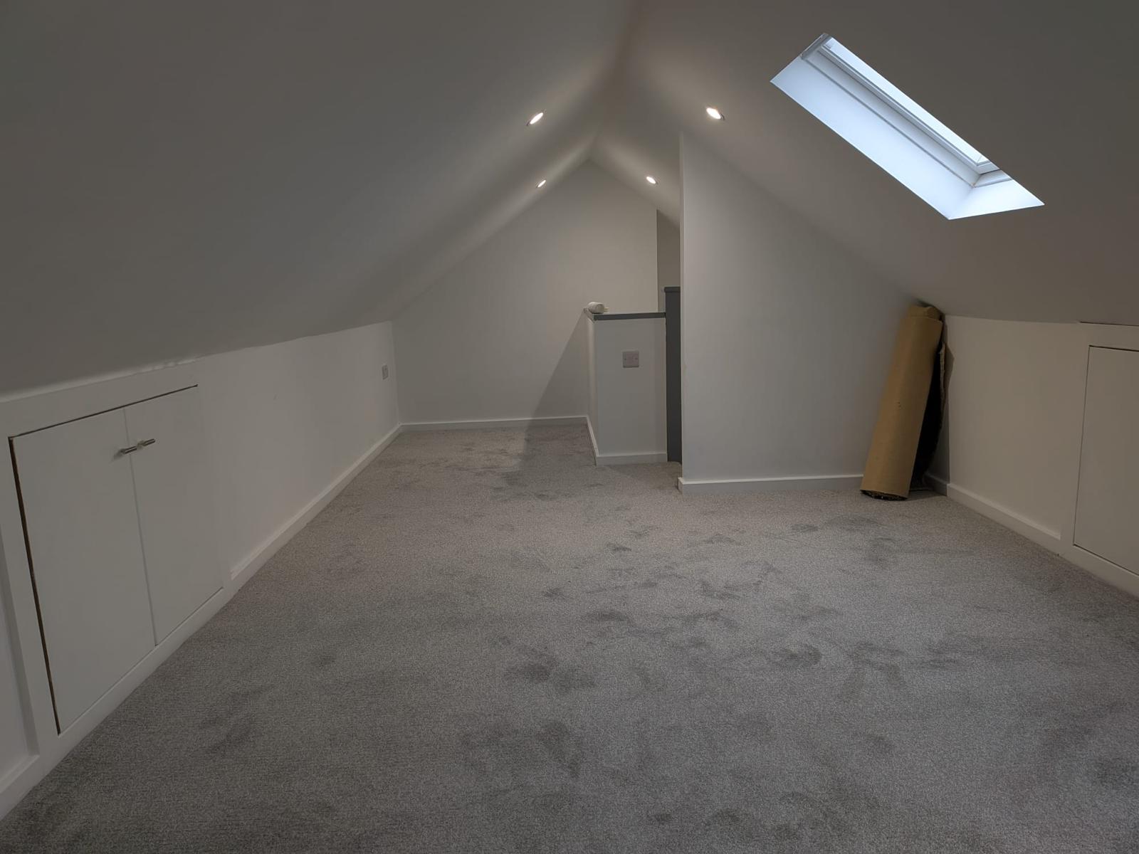 After — finished loft landing with built-in eaves storage