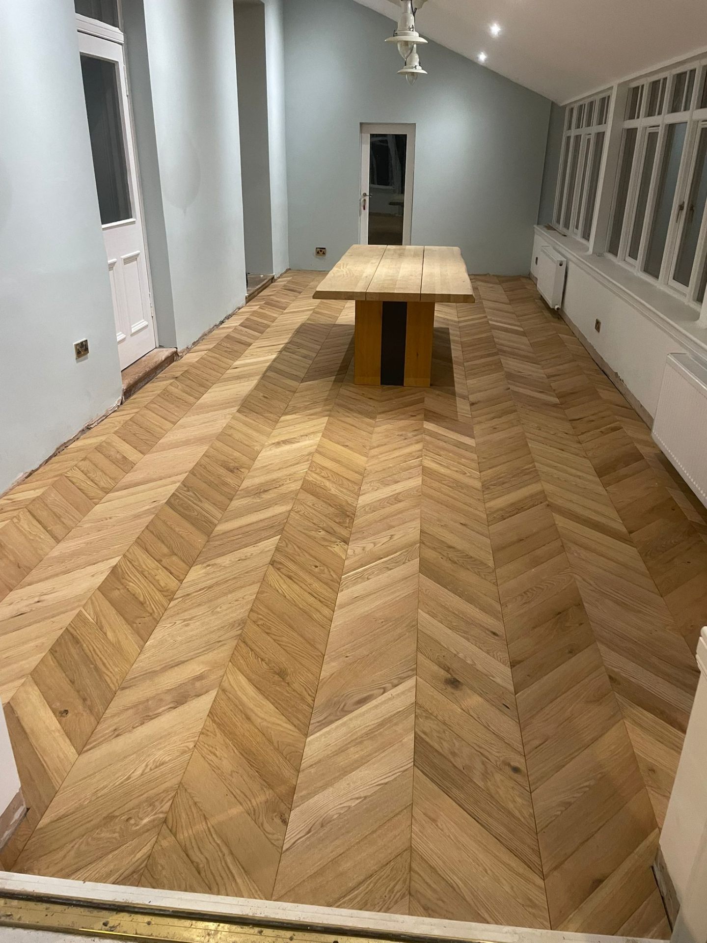 Chevron oak flooring installed in a Glasgow dining room