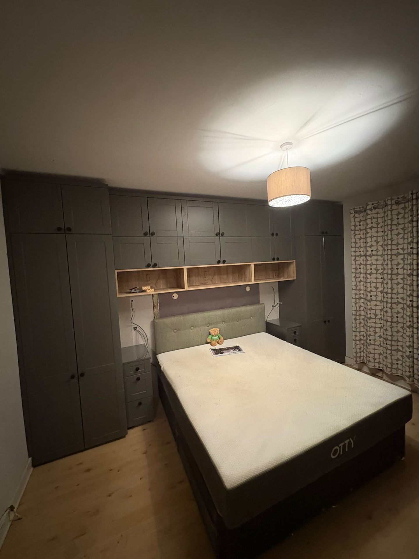 Fitted grey shaker bedroom with overbed storage
