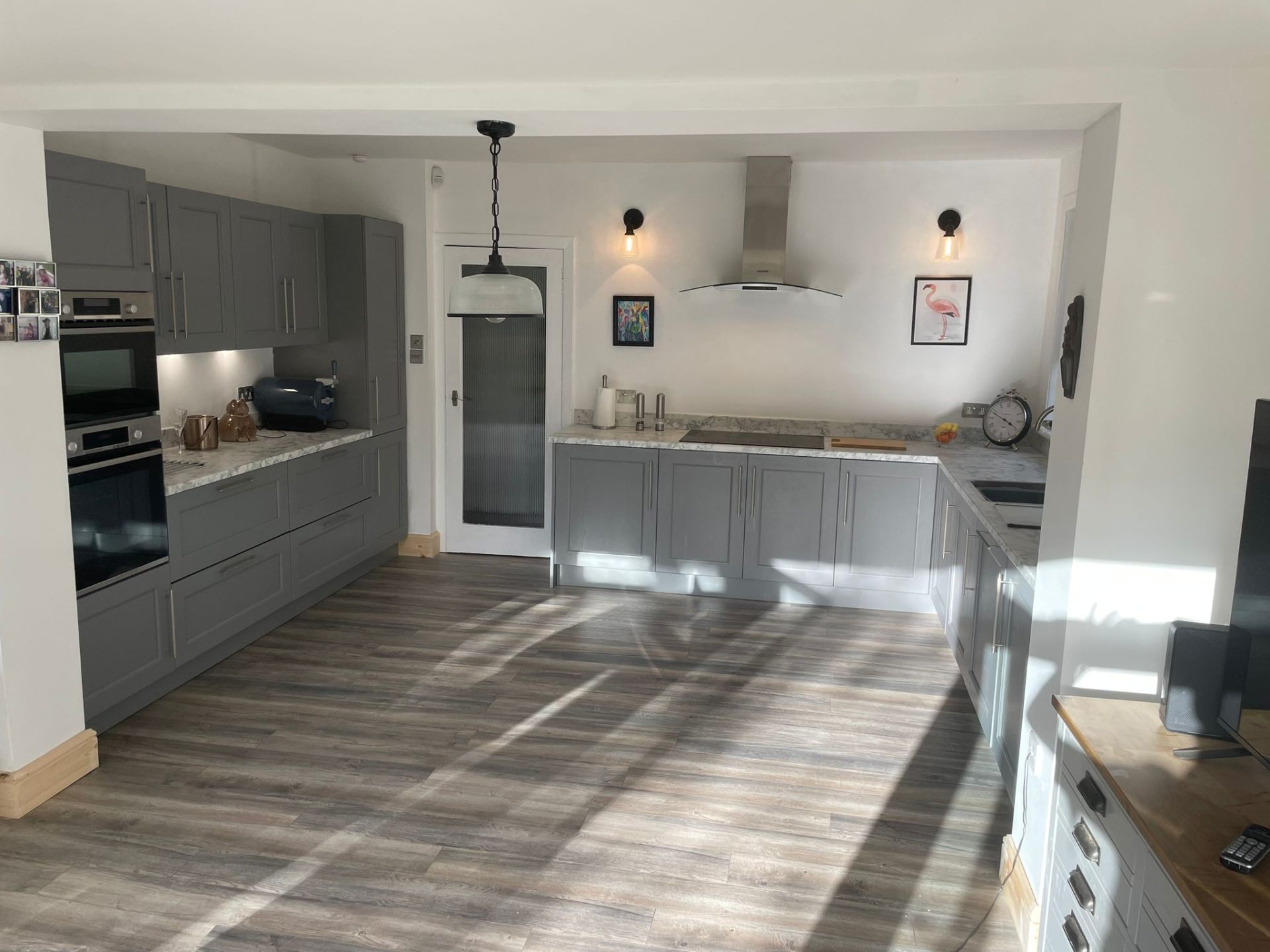 Grey shaker fitted kitchen with open-plan dining area in Glasgow